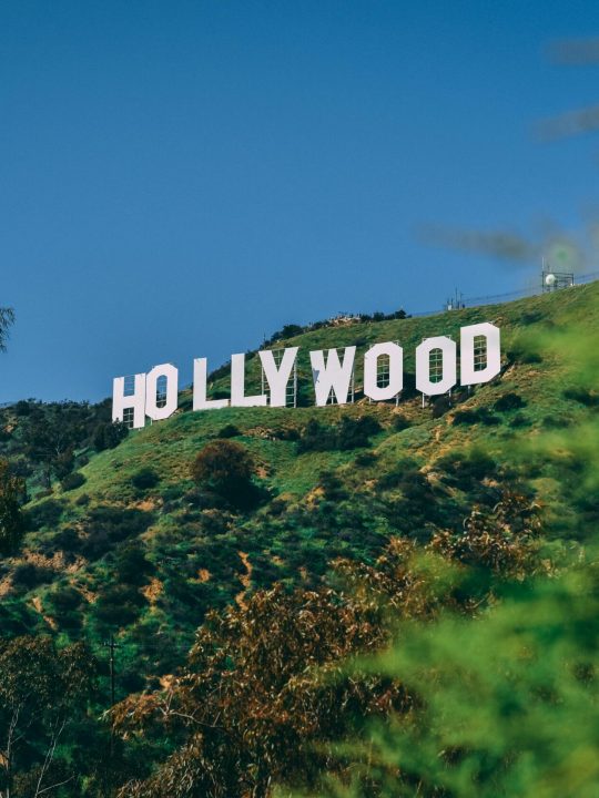 A scenic view of the famous Hollywood sign on a sunny day in Los Angeles.